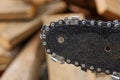 Gray steel chain on a chainsaw tire