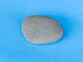 Gray stone isolated on blue background Royalty Free Stock Photo