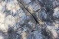 Gray stone rock texture background, cracked weathered surface with natural patterns and soft light shadows Royalty Free Stock Photo
