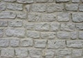 Gray stone wall featuring irregular, rough-textured stones arranged in a horizontal Royalty Free Stock Photo