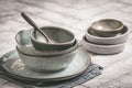 Gray stoneware plates and bowls on a rustic table Royalty Free Stock Photo