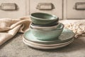 Gray stoneware plates and bowls on a rustic table Royalty Free Stock Photo