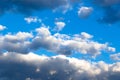 Gray storm clouds gather in the blue sky on a summer day. Several clouds are white Royalty Free Stock Photo