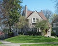 Gray Stucco House with Spring Trees & Flowers