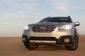 Gray Subaru in the sand of the Namib desert at a bright sky