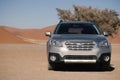 Gray Subaru in the sand of the Namib desert