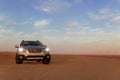 Gray Subaru in the sand of the Namib desert at a bright sky. Namibia