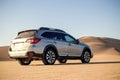 Gray Subaru in the sand of the Namib desert at a bright sky. Namibia