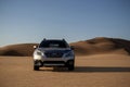 Gray Subaru in the sand of the Namib desert at a bright sky. Namibia