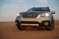 Gray Subaru in the sand of the Namib desert at a bright sky. Namibia