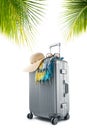 Gray suitcase with pareo and hat on white back