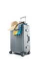 gray suitcase with pareo and hat on white background