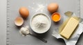 A gray surface holds baking ingredients: three brown eggs, one in its shell, another cracked with Royalty Free Stock Photo