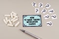 On a gray surface there are question marks and a sticker with the inscription - How to make taking medication easier