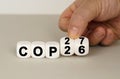 On a gray surface are white cubes with the inscription - COP26 to COP27