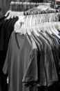 Gray t-shirts hanging on hangers