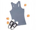Gray tank top with sneakers and fall leaves on white background
