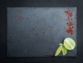 Gray textured board with laim and pepper Royalty Free Stock Photo