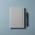 Gray textured notebook with an elastic band closure lies on a light blue textured Royalty Free Stock Photo