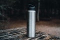 gray thermos flask of water on a wooden table with small drops of water Royalty Free Stock Photo