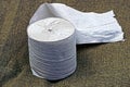 gray toilet paper roll lies on a green cloth Royalty Free Stock Photo