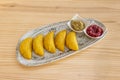 gray tray with delicious Colombian corn dough empanadas