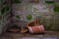 The gray und old stone wall and broken clay pot Royalty Free Stock Photo