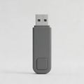 Gray USB Flash Drive with Button on Light Gray Background for Technology and Storage Use Royalty Free Stock Photo
