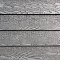 Gray vinyl siding with imitation wood grain Royalty Free Stock Photo