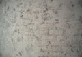 Gray wall inside the building with an unusual texture of concrete and brickwork. Royalty Free Stock Photo