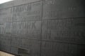 Gray wall with names of cities at the Immigration Museum in the port of Gdynia. Poland.