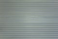 Gray white blue metal wall shield with horizontal lines and shadows. rough surface texture Royalty Free Stock Photo