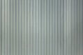 Gray white blue metal wall shield with vertical lines and shadows. rough surface texture Royalty Free Stock Photo