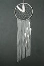 Gray white dream catcher on dark gray Royalty Free Stock Photo