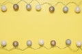 Gray white festive garland on yellow background flat lay top view. Cotton Balls Garland. Round bulbs LED festoon lights electric Royalty Free Stock Photo