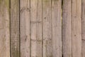 Gray white wall fence of dry wooden boards with slots between them. vertical lines. rough surface texture Royalty Free Stock Photo