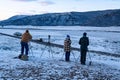 Gray wolf watchers watch the wolf pack along the tree line of Lamar Valley