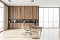 Gray and wooden CEO office interior with table, computer and bookcase, side view Royalty Free Stock Photo