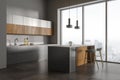 Gray and wooden kitchen corner with bar Royalty Free Stock Photo