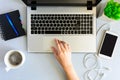 Gray wooden office desk table with laptop computer, smartphone,notebook, pen and cup of coffee. Royalty Free Stock Photo