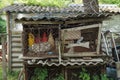 gray wooden rabbit cage with iron rusty grating and rubbish inside