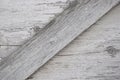 Gray wooden surface with cracks, knots and exfoliating white paint. Royalty Free Stock Photo