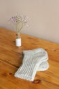 Gray woolen knitted socks on wooden table Royalty Free Stock Photo