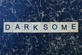 gray word darksome from wooden letters in black font