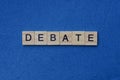 Gray word debate from small wooden letters