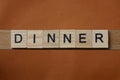 Gray word dinner made of wooden square letters