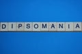 Gray word dipsomania in small square wooden letters Royalty Free Stock Photo