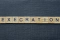 Gray word execration from small wooden letters