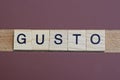 gray word gusto made of wooden square letters