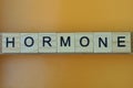 gray word hormone made of wooden square letters